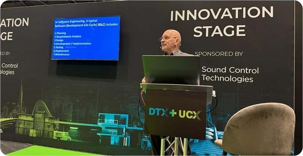 Speaker presenting the software development life cycle on the Innovation Stage at UCX London